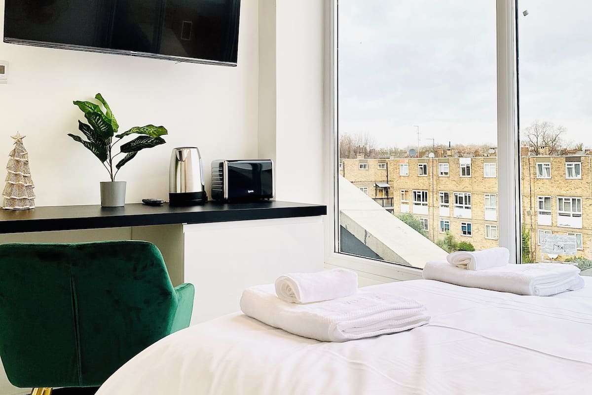 Desk, laptop workspace, blackout curtains, iron/ironing board