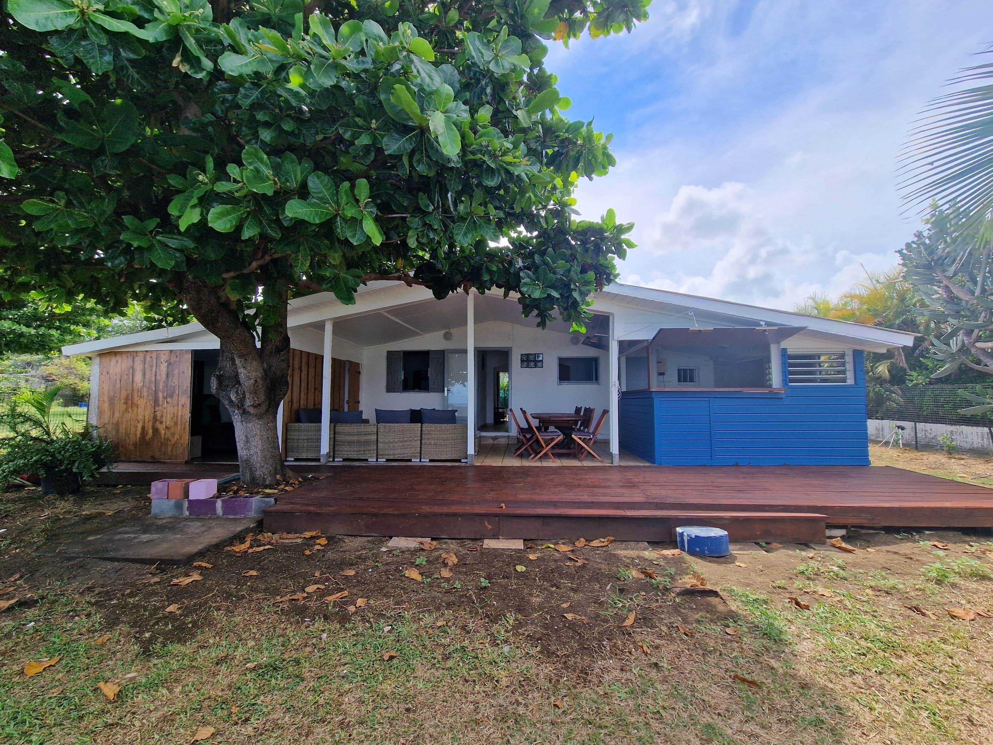 A house with a covered porch, a dining area, and a garage.