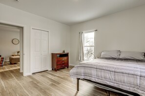 A bedroom with a bed, a dresser, a clock, and a window. - 1 Mi to Main Street! Cozy Concord Apartment (Concord)