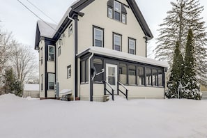 A two-story house with a large front porch, a covered entryway, and a snow-covered yard. - 1 Mi to Main Street! Cozy Concord Apartment (Concord)