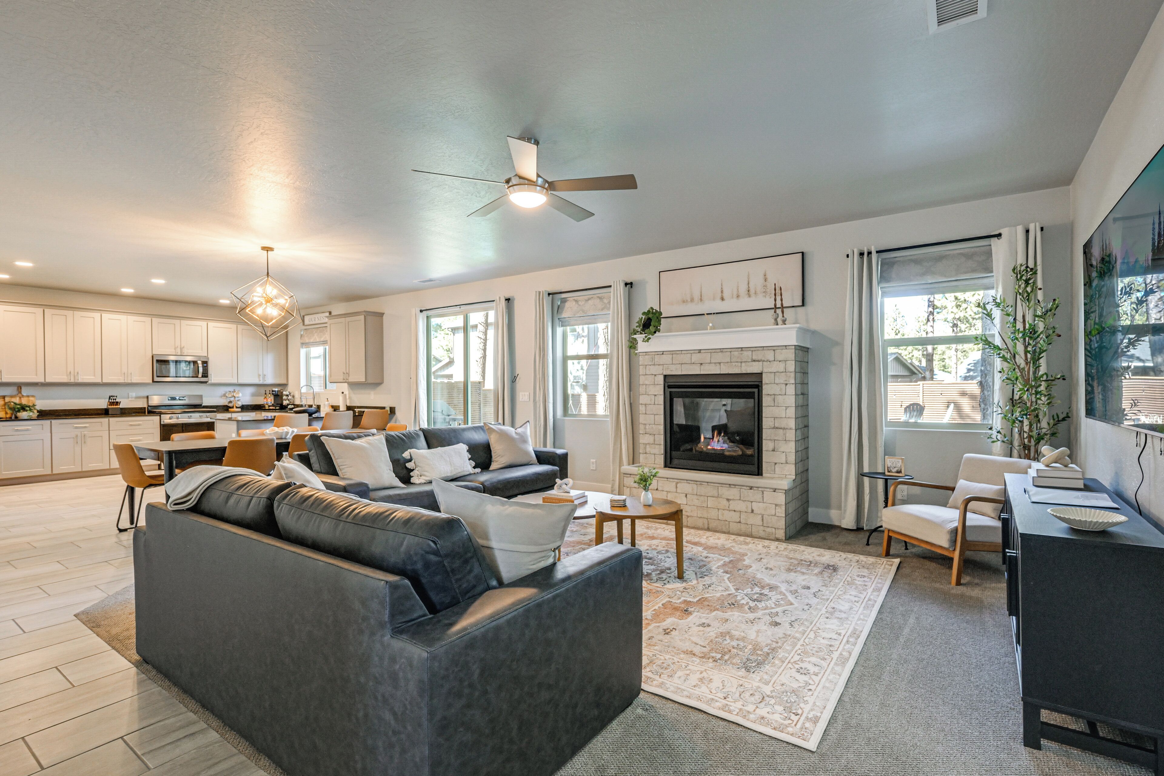 A spacious living area with a fireplace, a sofa, and a dining table.