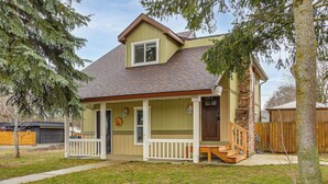 A two-story house with a front porch, a small deck, and a brick chimney. - Work & Play in Walkable Midtown Coeur D'alene! (Coeur d'Alene)