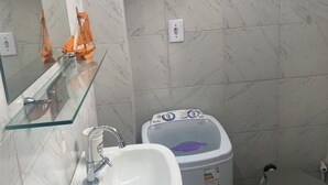A bathroom with a glass shelf, a sink, a toilet, and a water heater. - Carnival… 5 minutes from the subway, Lapa, beaches, Aterro, Sambadrome. (Rio de Janeiro)