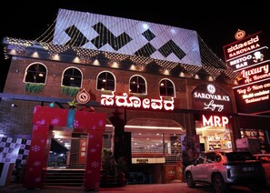 A building with a sign that reads 'Sarovara's Legacy' and 'MRP' indicating a restaurant. There is a two-wheeler parking sign visible. - Hotel Sarovars Legacy  (Bangalore)