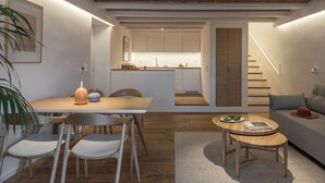 Un interior moderno con comedor, cocina y sala de estar.