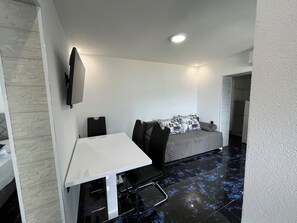 A modern bedroom with a bed, a desk, and a chair. - Modern New Apartment Near the Sea. Fabulous and breathtaking. (Dobrota)