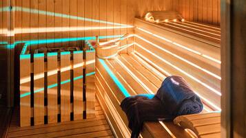 A wooden sauna with benches and a bench with a towel.