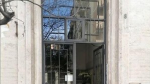 A building entrance with a glass door and a metal gate, leading to a staircase. - Wide and Bright, only a few steps from Colosseum & metro (Roma)