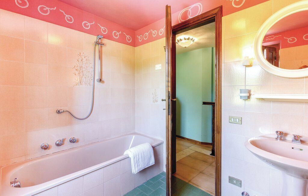 A bathroom with a bathtub, a shower, and a sink.