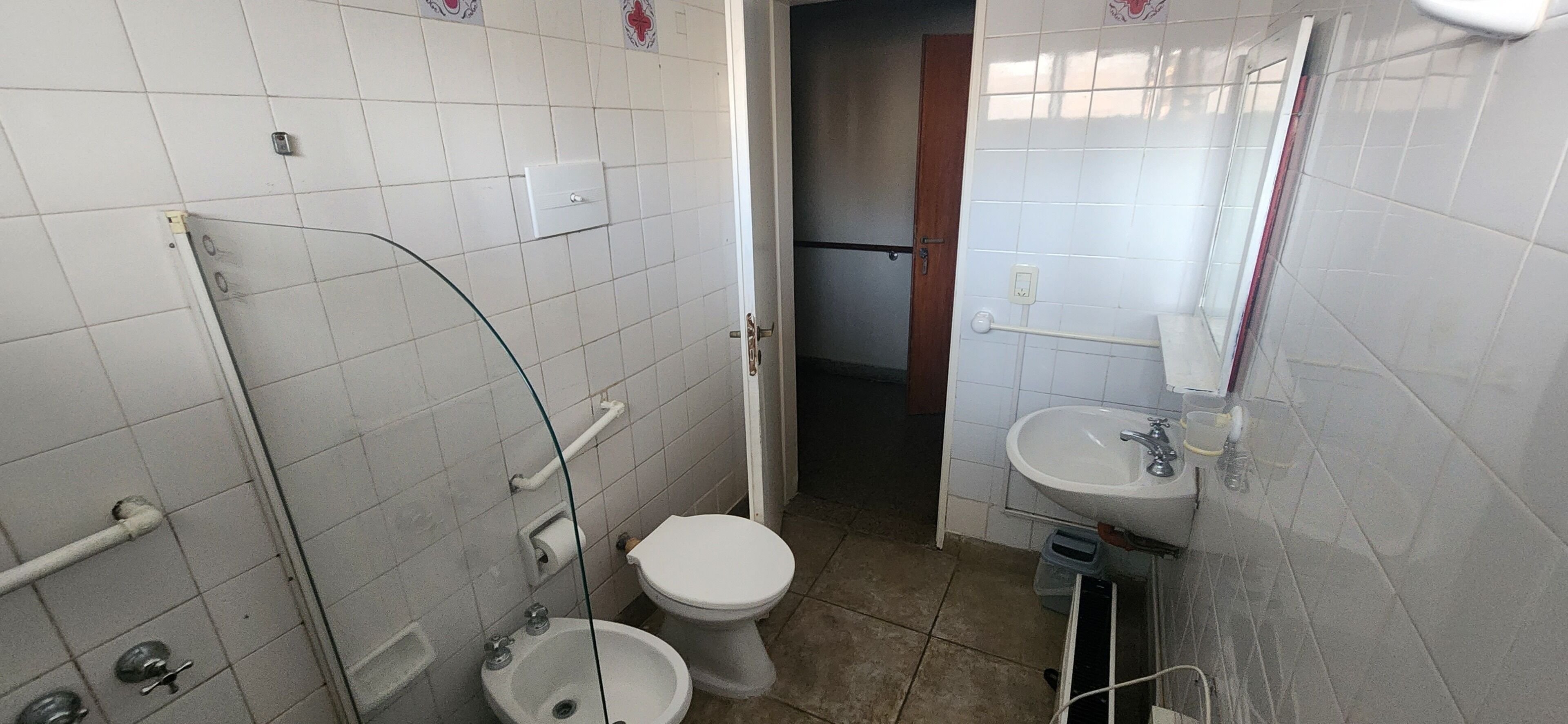 A small bathroom with a toilet, bidet, and sink.