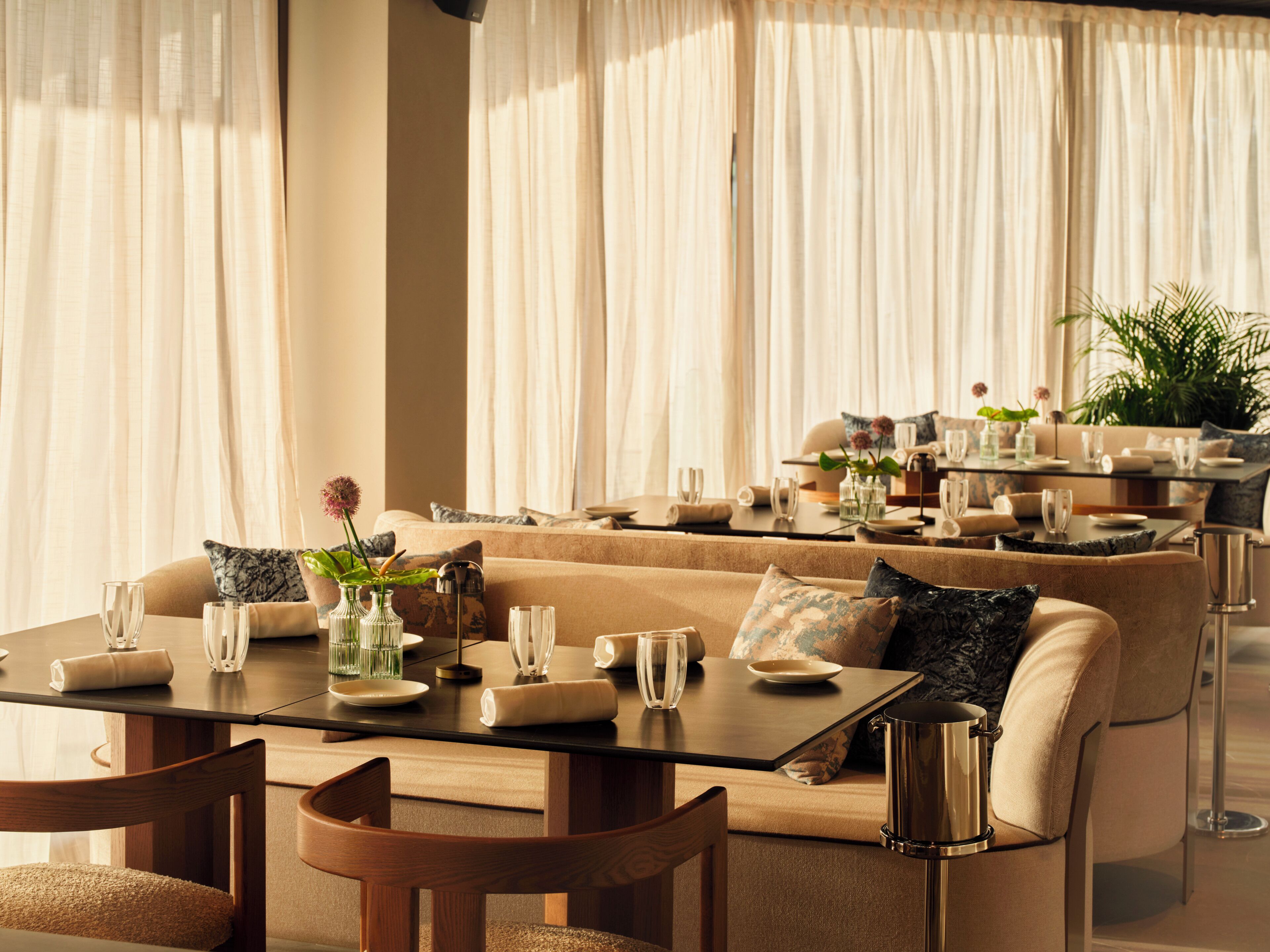 A well-appointed dining area with a sofa, dining table, chairs, and a coffee table.