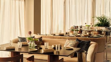 A well-appointed dining area with a sofa, dining table, chairs, and a coffee table.