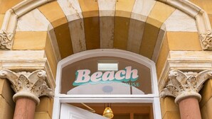 A building entrance with a sign that reads "Beach House." - Beach House Rooms (Scarborough)