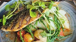 A plate of grilled fish with vegetables and a side of bread. - The Huntsman (Strumpshaw)