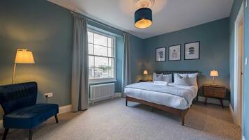 Desk, iron/ironing board, bed sheets