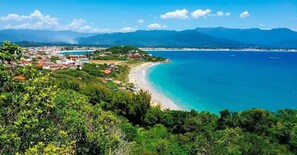 A coastal town with a beach, surrounded by mountains. - Paradise of the Sertão (Enseada de Brito)