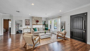 A spacious living room with hardwood flooring, a neutral color scheme, and modern furniture. - The Blue Heaven/ Poolside Retreat Near Brickell / Sleeps 13 (Miami)