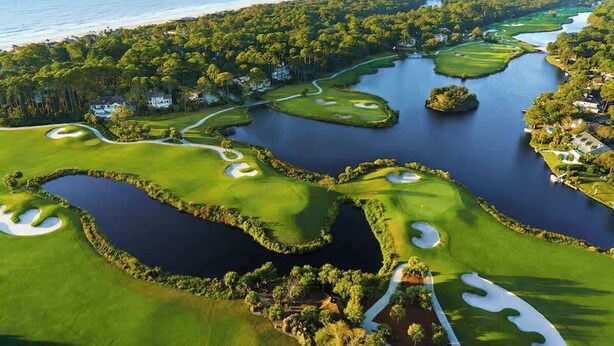 A golf course with water hazards, sand bunkers, and a view of the ocean. - Private Pool, Lagoon View, & Walk to Beach! (Hilton Head Island)