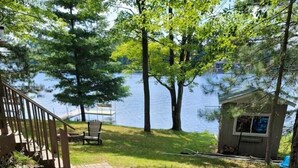 A brick pathway leading to a deck with a view of a lake. - Cozy 2 bedroom cottage on lake! (Mountain)