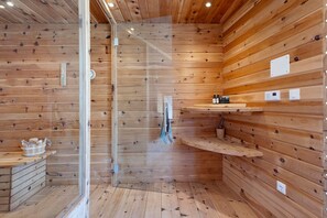 A wooden interior with a glass shower enclosure, wooden shelves, and a small wooden cabinet. - Apartment 'Lisahitl' with Shared Pool, Private Terrace and Wi-Fi (Renon)