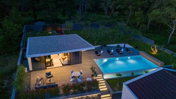 A modern house with a swimming pool, outdoor seating, and a well-maintained garden. - Luxury Matos Estate With Heated Pool (Zadar)