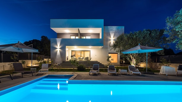 A modern two-story house with a swimming pool, outdoor seating, and a well-lit entrance. - Apartment Vista Mare 2 With Heated Pool (Sveti Filip i Jakov)