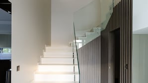 A modern staircase with glass railings and integrated lighting. - Villa Positiva With Heated Pool (Vir)