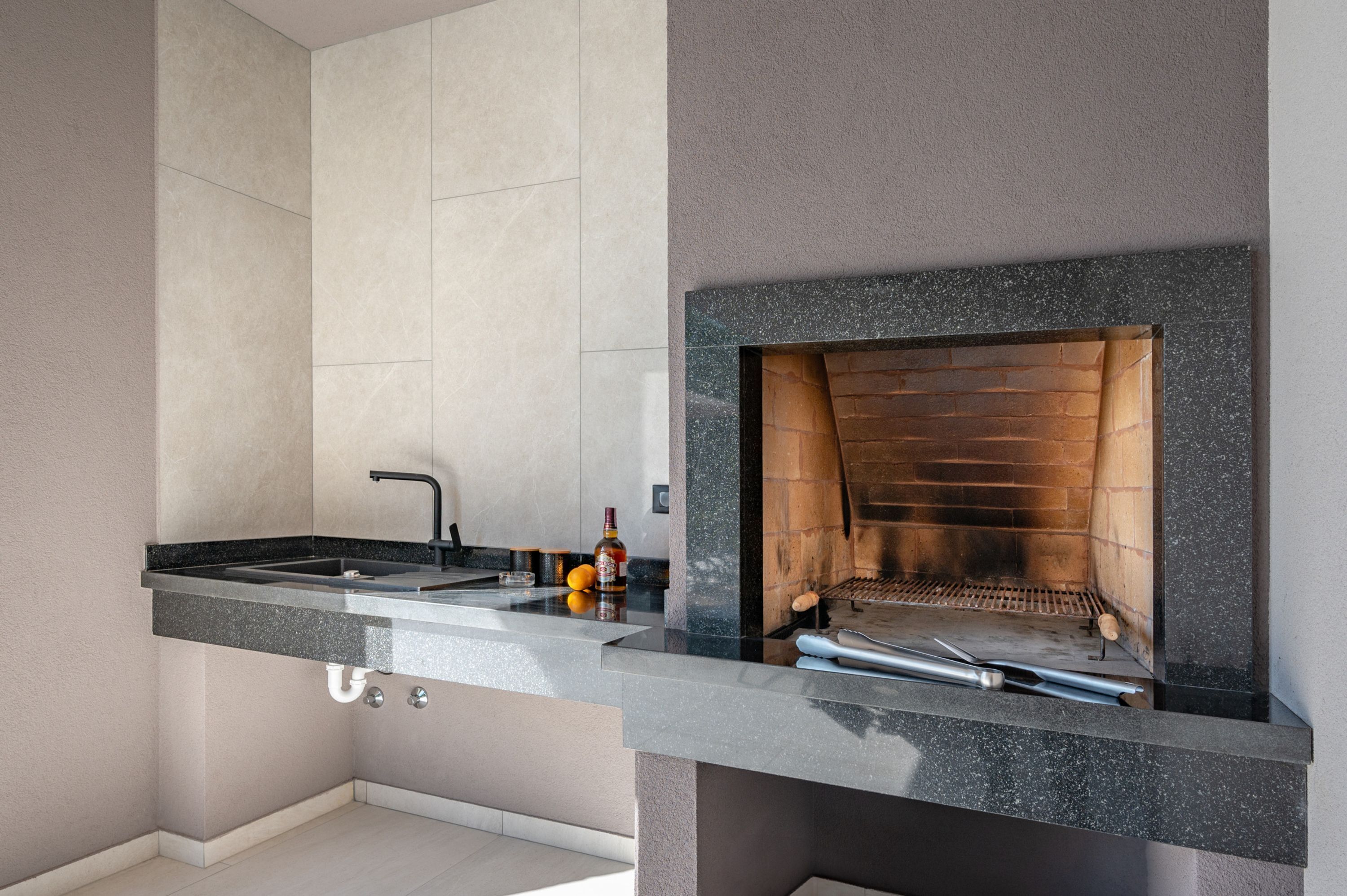 A modern kitchen with a built-in oven and a sink.