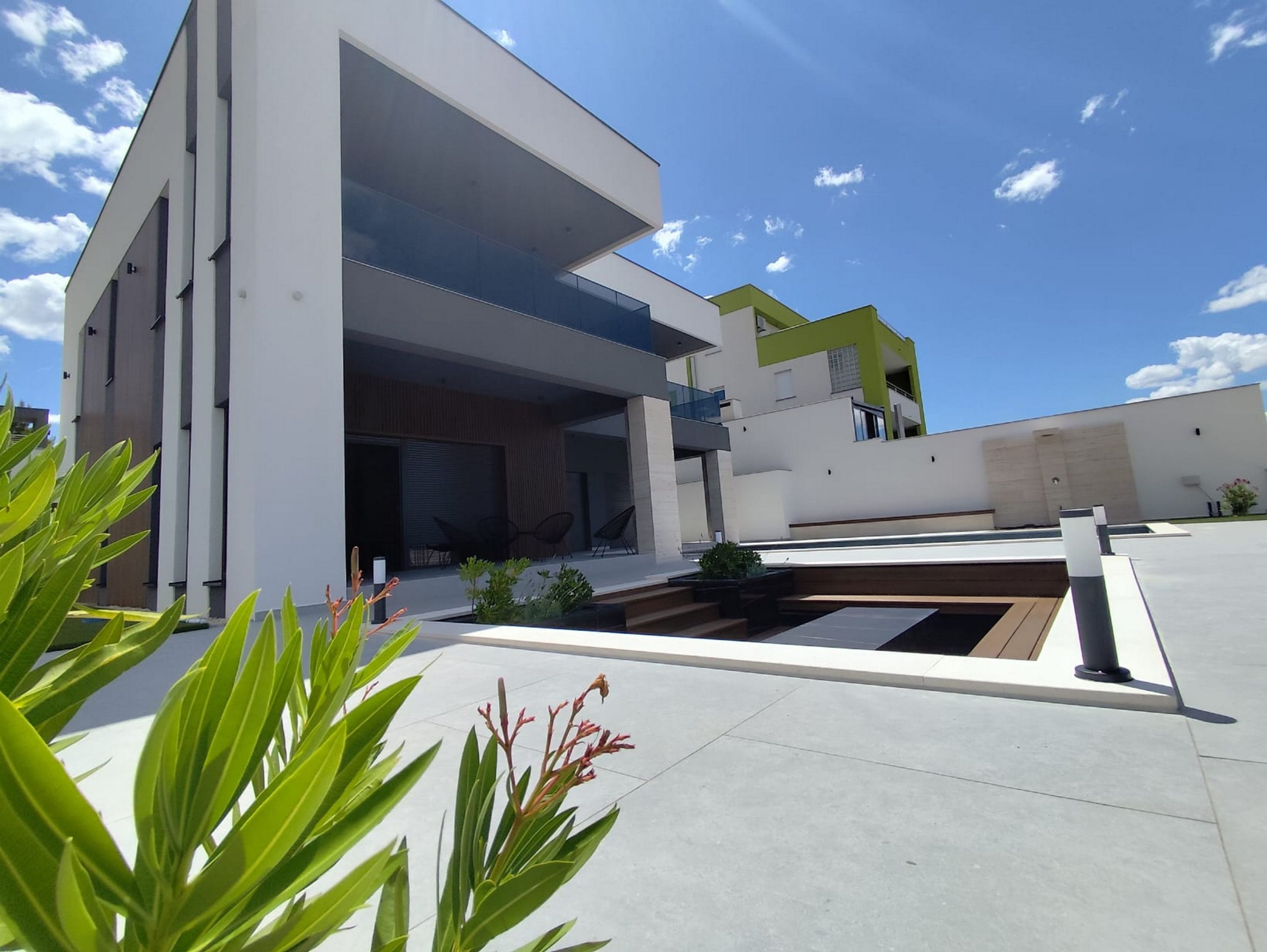 A modern building with a flat roof, large windows, and a flat facade.