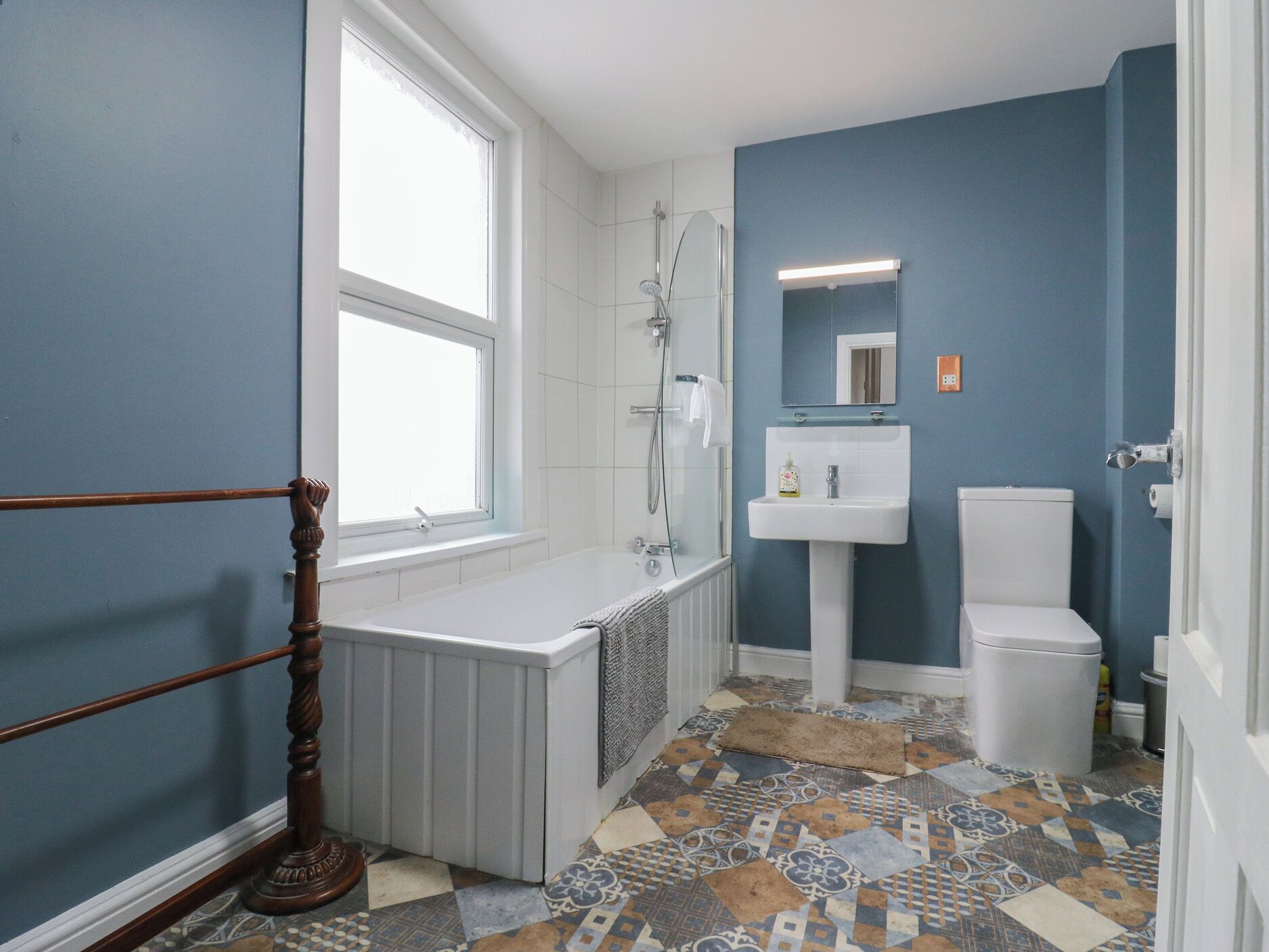 A bathroom with a bathtub, a toilet, and a sink.