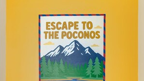 A room with a yellow wall, a poster titled "ESCAPE TO THE POCONOS", a blue round table, and a black cushioned bench.