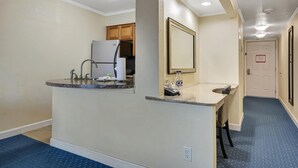 A compact kitchen with a refrigerator, sink, and countertop. - Sunset Cove – Tampa Sunsets from Your Balcony (Tampa)
