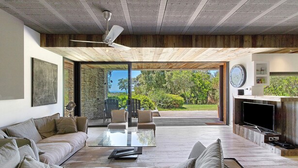 A modern living room with a sofa, a coffee table, and a fireplace. - Holiday Home “Loft 2 – Sea View with Pool”, Wi-Fi and Air Conditioning (Porto-Vecchio)