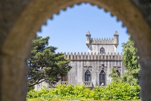 A historic building with a tower, arched windows, and a stone facade.