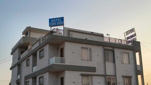 Ein mehrstöckiges Gebäude mit einem Schild, das anzeigt, dass es sich um ein Hotel namens 'Funday Grand' handelt.
