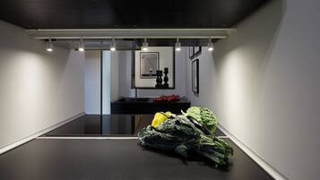A modern kitchen with a black countertop, a sink, and a potted plant.