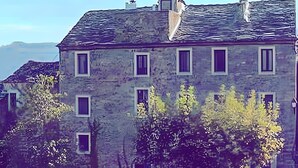 A stone building with multiple windows and a chimney. - Suite Nostalgie-Casa Ghjunca (Rapale)