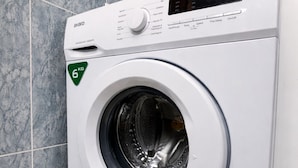 A front-loading washing machine with a digital control panel, a 6kg capacity label, and a control knob. - Renovated apartment with pool and 2 minutes from the beach. Quiet location (Els Muntells)