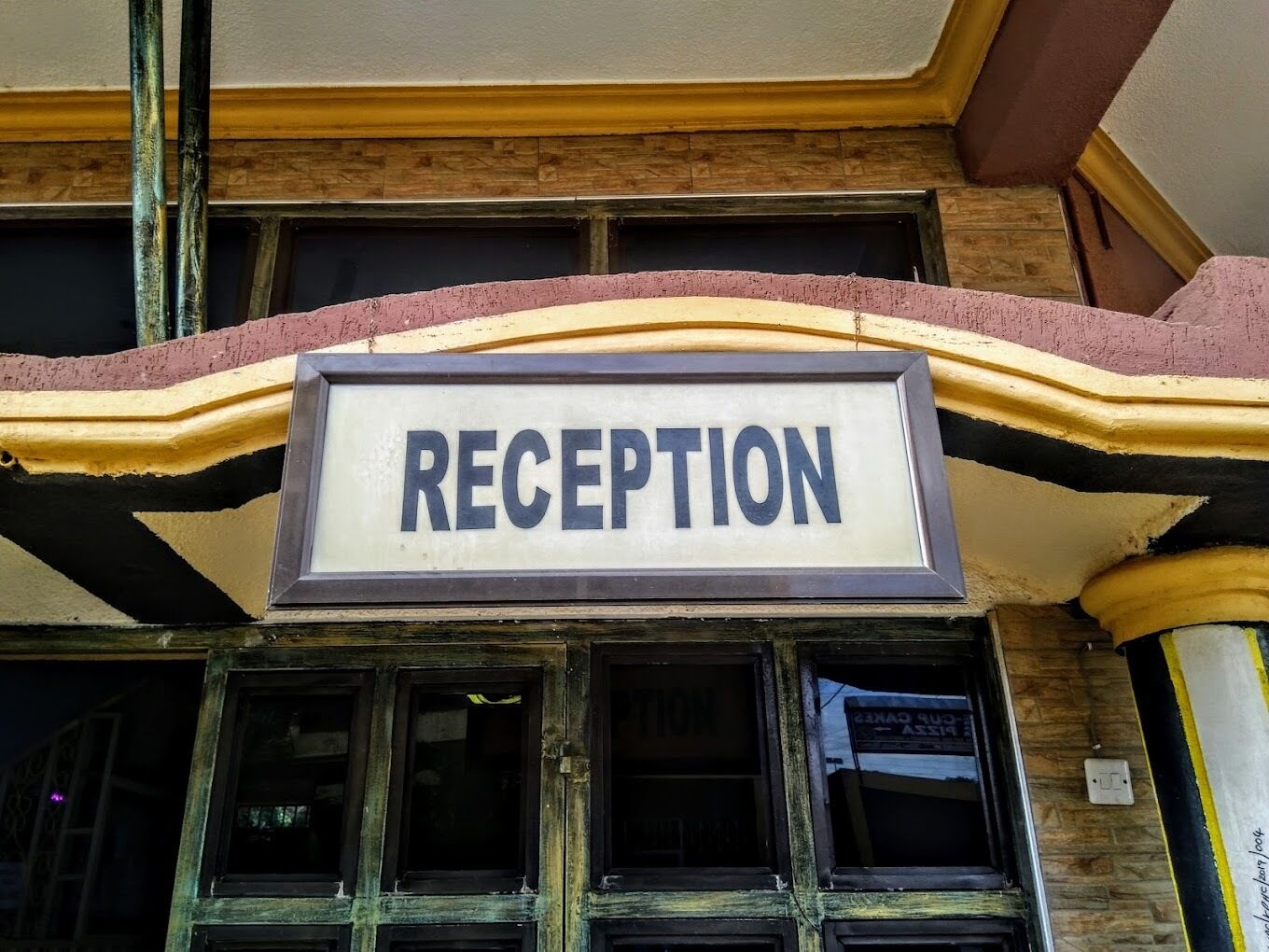 A reception sign above a building entrance.