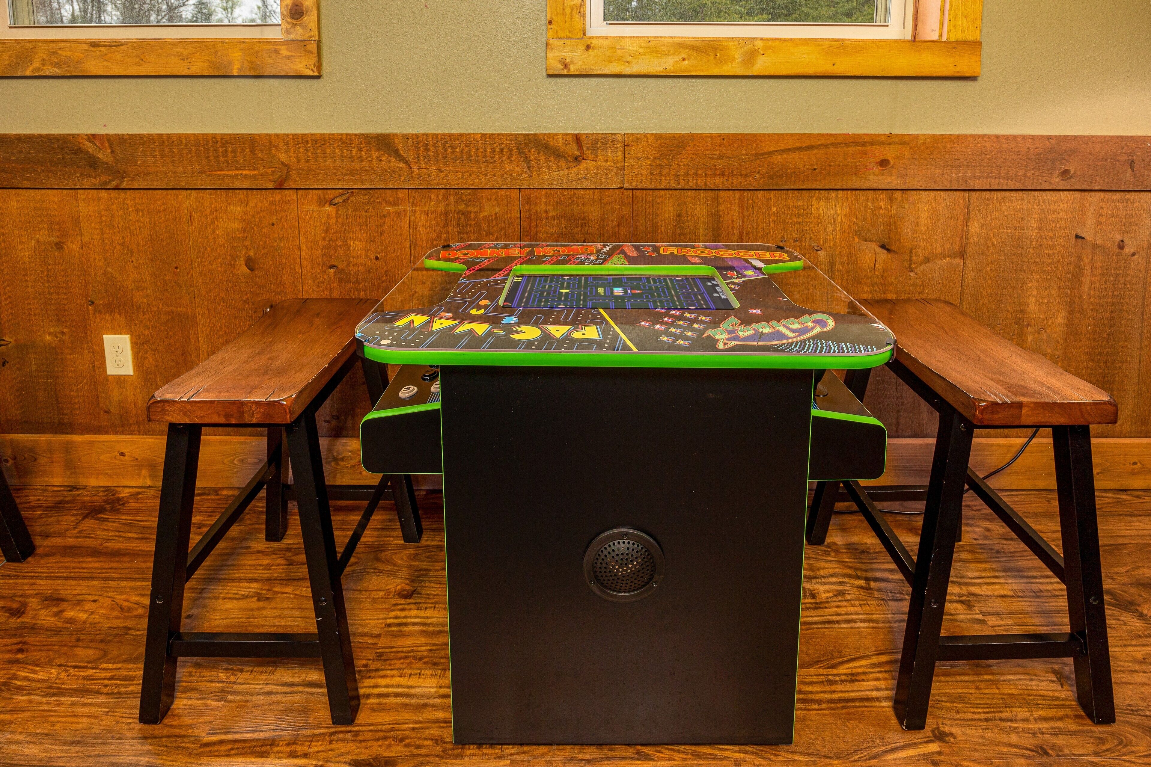 A wooden table with a black electronic device on it.