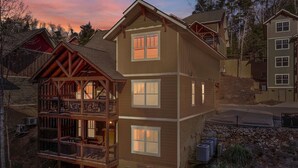 A two-story house with a balcony and a garage. - Splash Mansion (Gatlinburg)