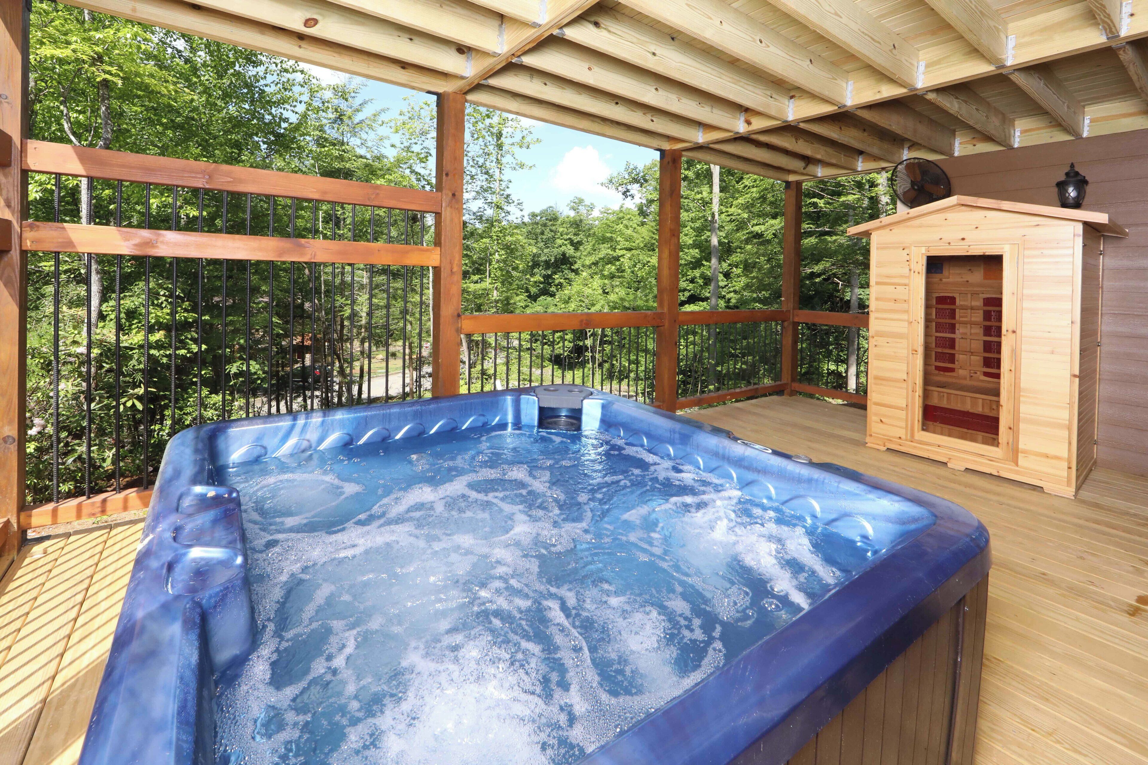 A hot tub with a wooden deck and a sauna.