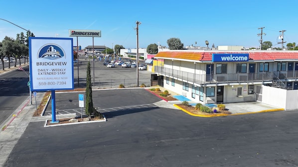 A parking lot with a sign for Bridgeview offering daily and weekly extended stay rates.