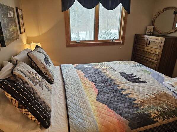 A bedroom with a bed, a window with a view of trees, a dresser, and a lamp. - Timberline Lodge. Vaulted Ceilings, Fireplace & Walk-to-Slopes Access in Canaan Valley (Davis)