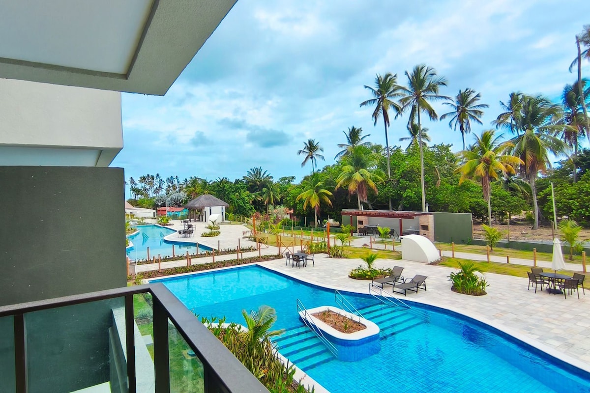 Ein Pool mit einer Liegeinsel, umgeben von Liegestühlen und einem kleinen Garten.