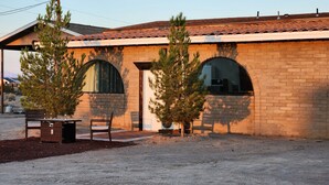 A building with a brick facade, arched windows, and a tiled roof.
