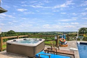 A hot tub, a pool, and a water slide in a backyard with a view of the countryside. - Pool | Hot Tub | Pickleball | Firepit (Williamstown)