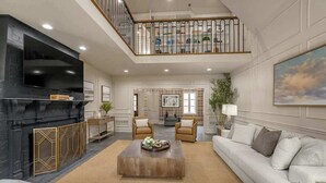 Un amplio salón con chimenea, televisor y una cómoda disposición de asientos.