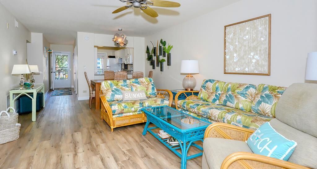 A living room with a sofa, armchairs, a coffee table, and a dining area with a table and chairs.