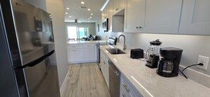 Fridge, microwave, oven, stovetop - A103 - Gulffront Getaway at Fisherman’s Cove | Steps to Sand, Free Boat Docks (Sarasota)